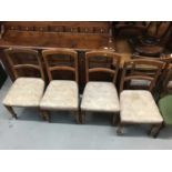 Set of six Victorian walnut dining chairs with bar backs, over-stuffed seats on turned and faceted f