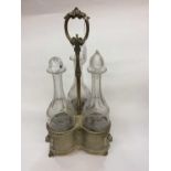Set three etched glass decanters within plated stand