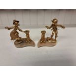 Pair of 20th century gilt metal candle holders in the form of a boy and girl