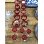 Group of cranberry overlaid wine glasses and others