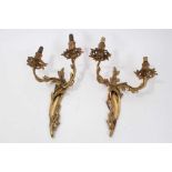 Pair of Rococo style gilt metal wall sconces, each scrolling foliate bracket issuing twin arms, 31cm