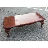 Reproduction hardwood coffee table of rectangular form with cabriole legs