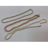 Two cultured pearl necklaces with 9ct gold clasps and pink cultured pearl necklace with gilt metal T