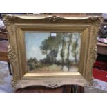 Edwardian watercolour depicting a tree lined river landscape, indistinctly signed, dated 1903, in go