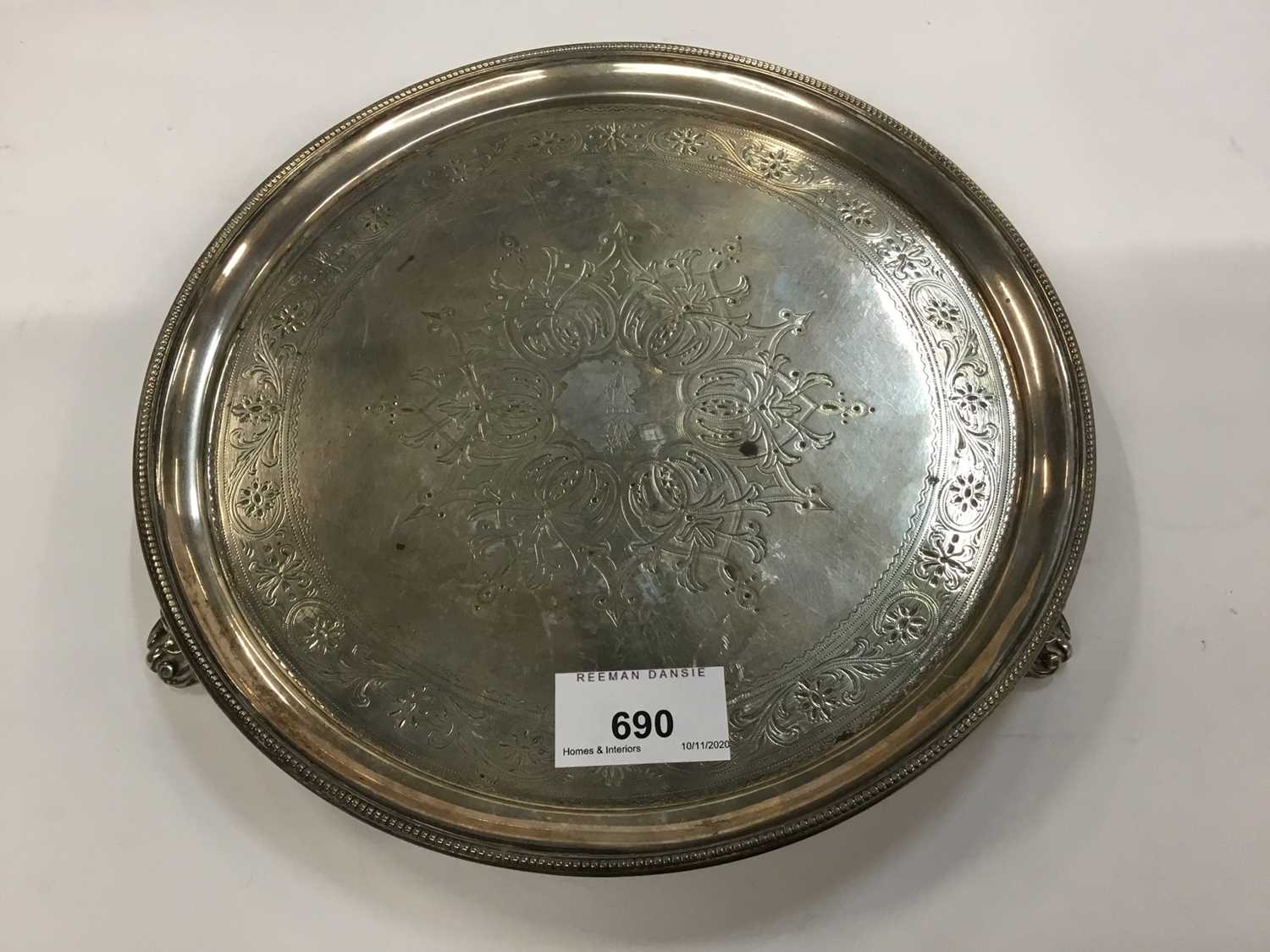 George III silver salver of circular form on three scroll feet, with later engraved decoration, Lond