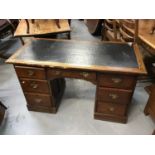 Edwardian oak kneehole desk with seven drawers