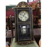 1920s wall clock with 8 day striking movement in Arts & Crafts-style gilded black lacquered case