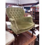 Victorian-style easy chair with green velvet upholstery, on square legs