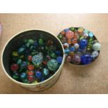 Tin containing a quantity of vintage marbles