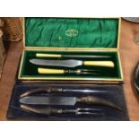 Three piece steel carving set with horn handles in fitted case together with another similar set by