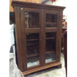 Oak bookcase with shelved interior enclosed by two glazed doors