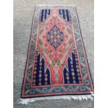Eastern rug with geometric decoration on red and blue ground, 203cm x 97cm