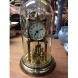 Brass anniversary clock under glass dome