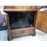 Samsung flatscreen television contained in a mahogany television cabinet