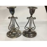 Pair of late Victorian silver candlesticks with lyre support, on oval bases, London 1900 (one broken