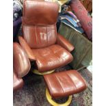 Contemporary brownish red leather revolving reclining armchair with matching footstool