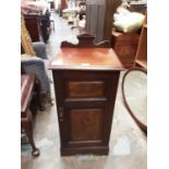 Edwardian walnut pot cupboard, 41cm wide, 86cm high, 37cm deep, and a mahogany framed oval bevelled