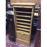 Oak stationery cabinet with numerous slides and tambour shutter