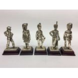 Group of five plated military figures on wooden bases