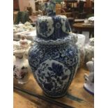 Large Delft pottery blue and white vase and cover and two Chinese porcelain ginger jars