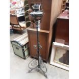 Early 20th century oil lamp on metal stand