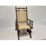 Antique children's rocking chair with turned supports