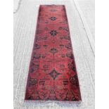 Eastern runner with geometric decoration on red and blue ground, 277cm x 84cm