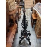 Two early 20th century wrought iron oil lamp stands converted into standard lamps