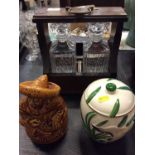 Two bottle tantalus together with two ceramic storage jars (3)