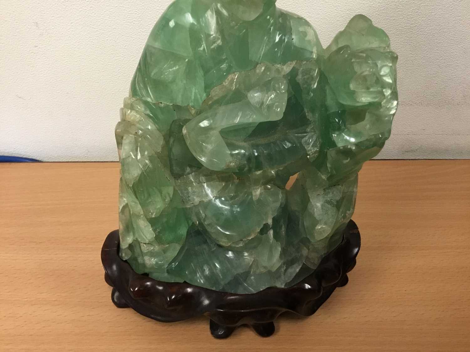 Oriental carved hardstone sculpture of a seated figure and dog of Fo, on carved hardwood base, 24cm - Image 3 of 5