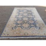 Large rug with floral decoration on blue and cream ground, 298cm x 204cm