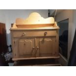 Victorian pine chiffonier with raised shaped ledge back, single drawer and two panelled doors below,