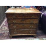 George I style burr walnut veneered chest of four long graduated drawers with brass handles on brack