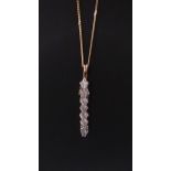 9 CT Gold Drop Down 7 Stone Pendant on a 9 CT Gold Chain , 6 Diamonds = 1CT 1 Pear Shaped