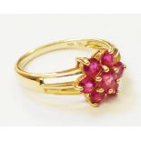 A marked 14k ruby flowerhead ring