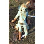 A painted cast iron garden seated fairy