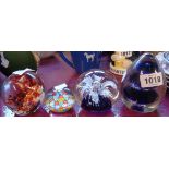 Four glass paperweights