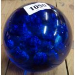 A large blue glass paperweight