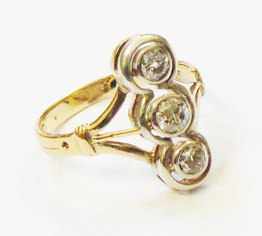 A marked 18ct. yellow metal ring with a row of three open collar-set diamonds