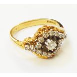 A hallmarked 18ct. gold diamond cluster ring of hooked cross-over design - London 1971