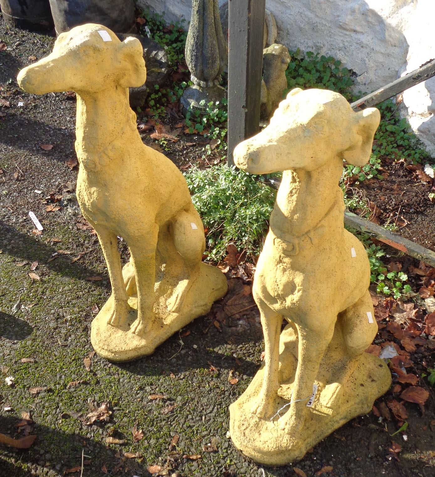 A pair of seated dog garden statues