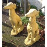 A pair of seated dog garden statues