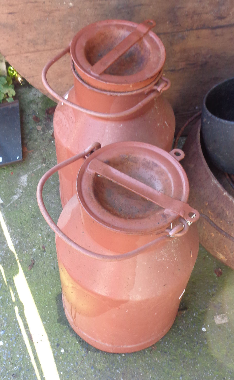 Two small old milk churns