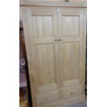 A 3' 8" modern waxed pine double wardrobe with hanging space enclosed by a pair of panelled doors