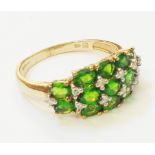 A hallmarked 375 gold diopside and tiny diamond set ring