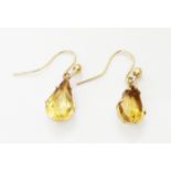 A pair of 9ct. gold drop ear-rings, set with pear cut citrines