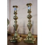 A pair of 19th Century brass beehive and diamond pattern ejector candlesticks