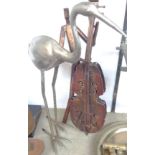 A white metal heron and a stylized double bass player