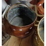 A hammered copper coal bucket