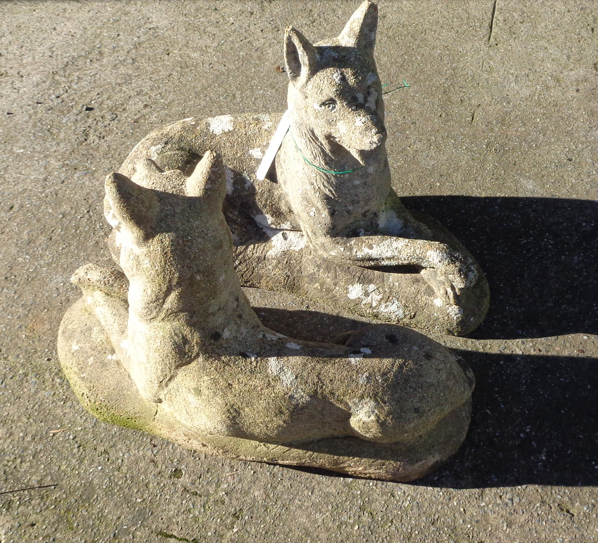 A pair of concrete garden dogs